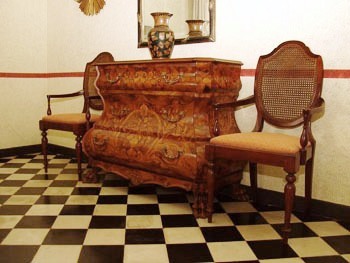 This photo of a display of fine continental antique furniture was taken by an unknown photographer.